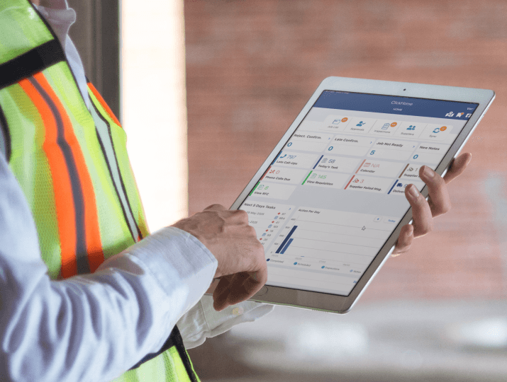 Construction supervisor using tablet field software to access call-sheets, documents, and site information